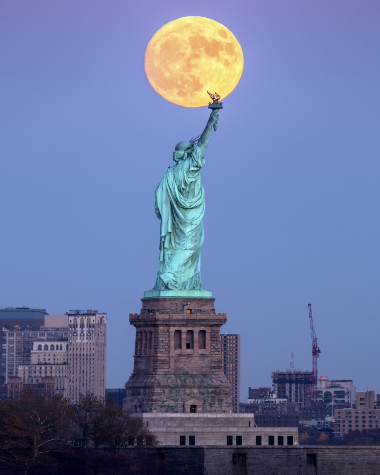  The supermoon appears like the glow of the Statue of Liberty's torch in New York