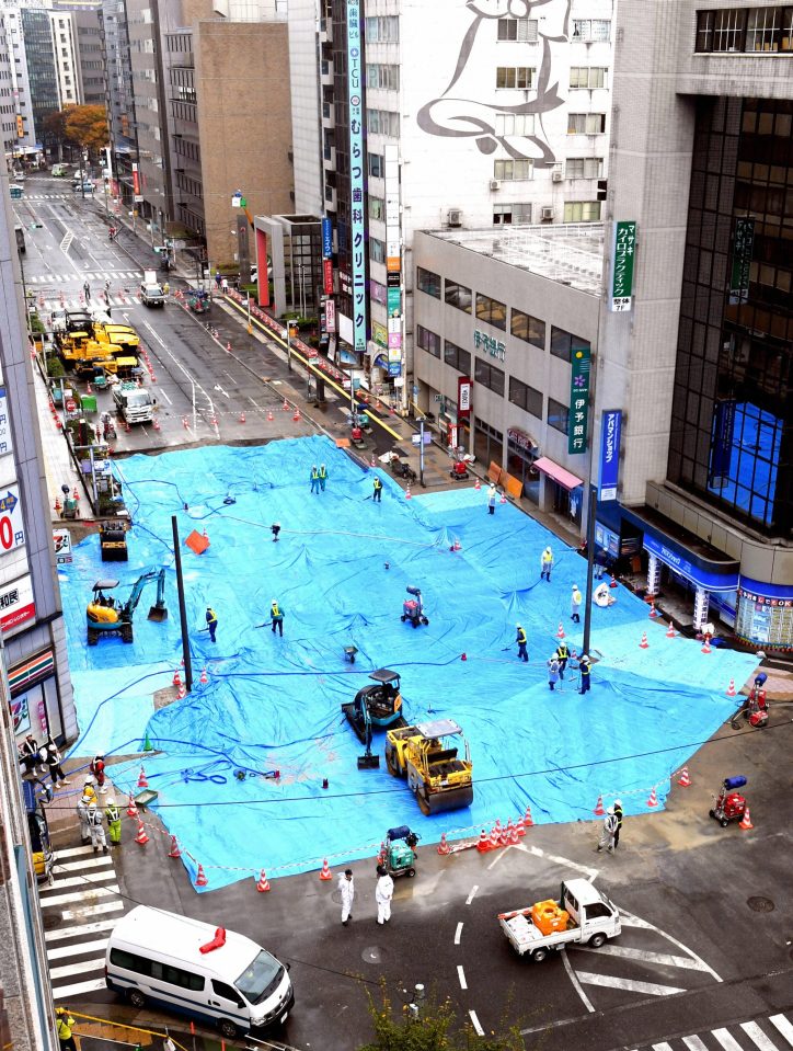  The sinkhole covered with blue sheets when restoration work was almost completed yesterday