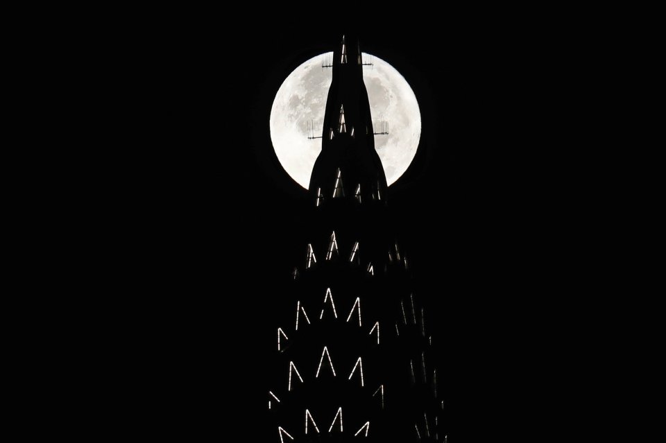  The supermoon sets behind the Chrysler Building in New York this evening