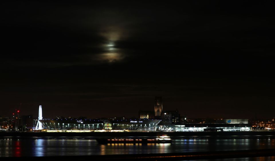  The supermoon can barely be made out through the clouds above Liverpool's Anglican Cathedral this evening