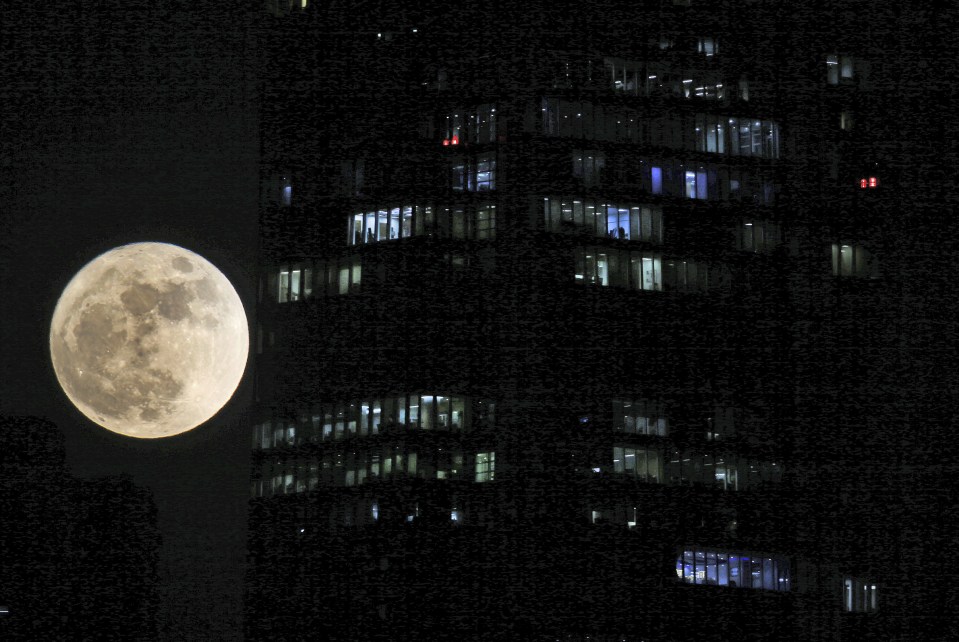  The supermoon rises behind the skyscrapers in Dubai, United Arab Emirates