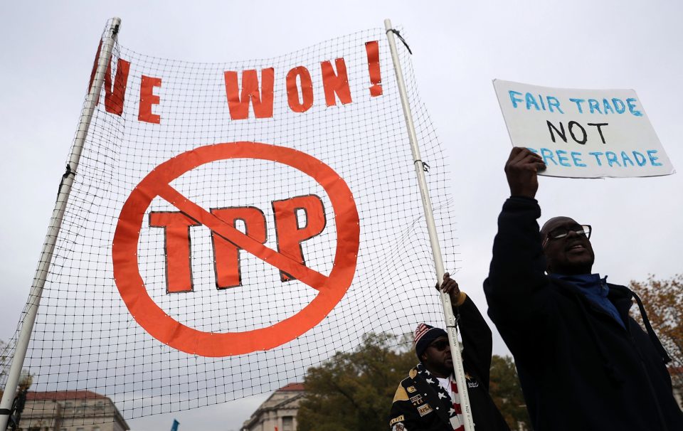  Activists shout slogans as they march during an anti-Trump and anti-TPP protest on November 14, 2016 in Washington, DC