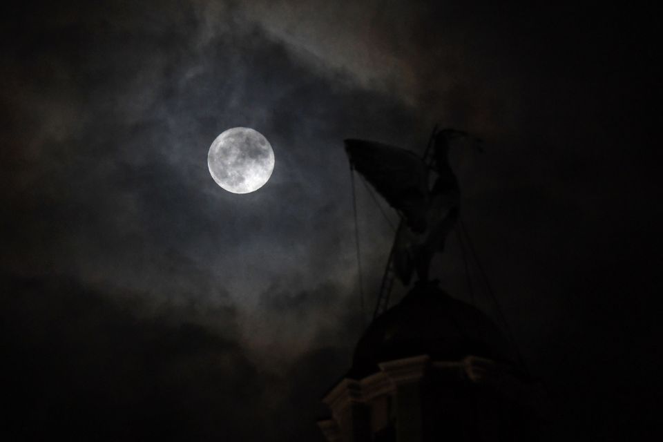  The giant moon breaks through the clouds, beyond one of the iconic Liver Birds on top of The Royal Liver Building in Liverpool