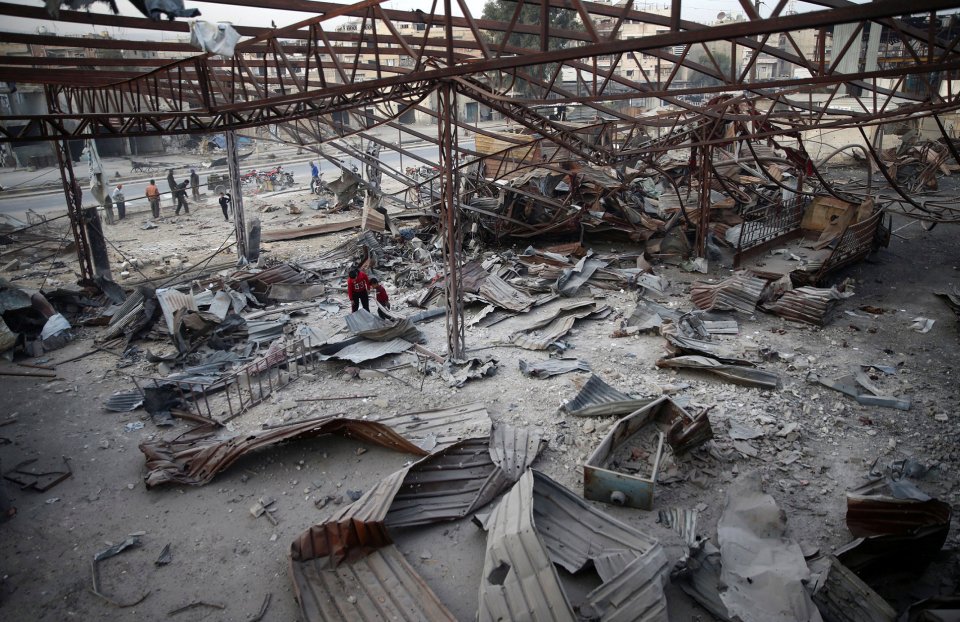  People inspect the damage at a site hit yesterday by airstrikes in the rebel held besieged Douma neighbourhood of Damascus, Syria