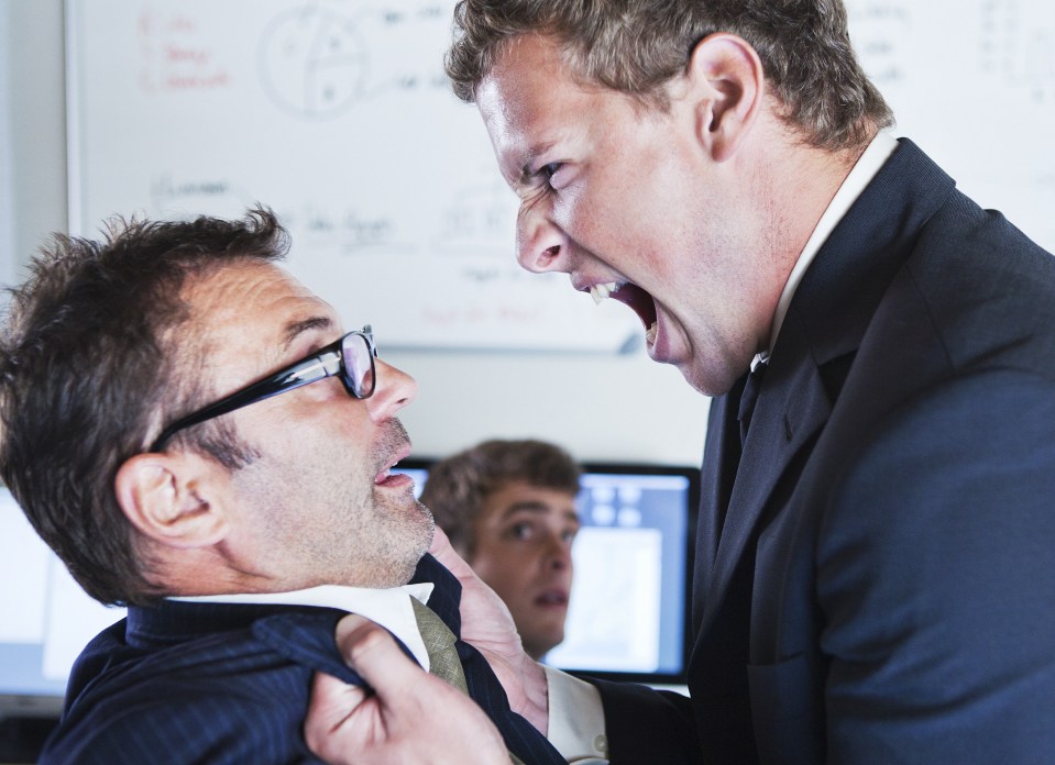 Man holding and shouting at co-worker