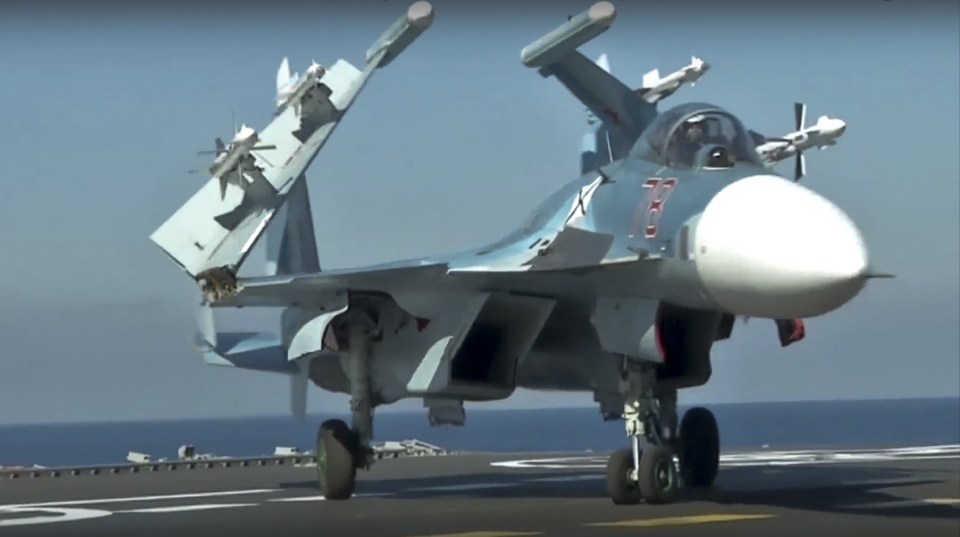 A Russian Su-33 fighter jet stands on the flight deck of the Admiral Kuznetsov aircraft carrier in the eastern Mediterranean Sea