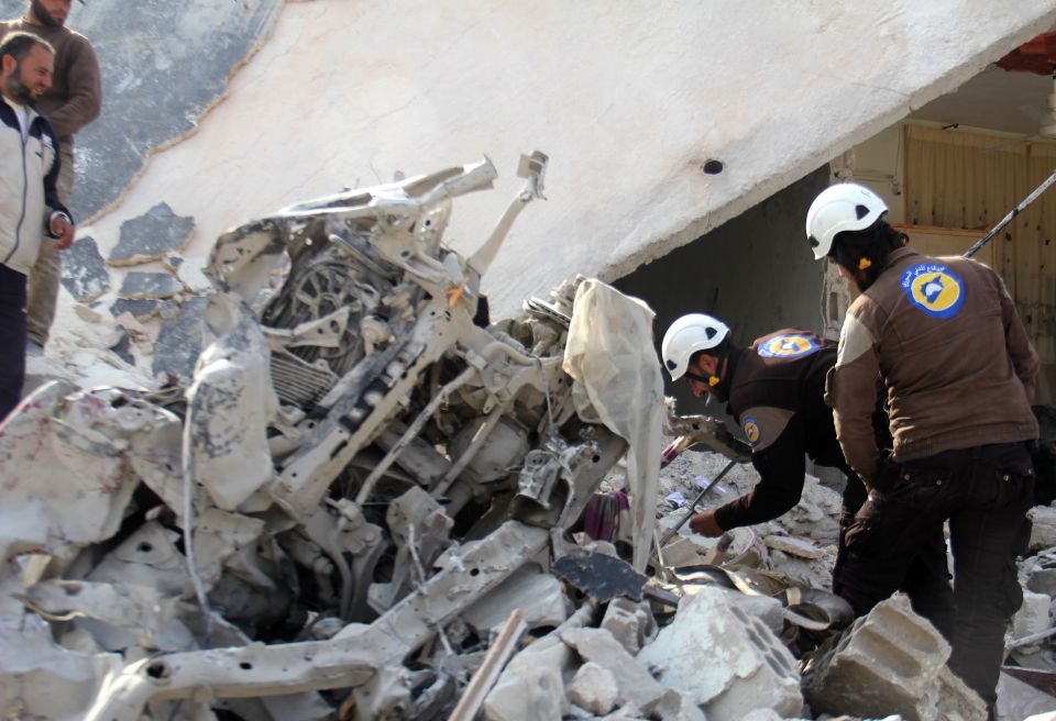 Rescue workers look for survivors after Russian and Syrian warplanes bomb rebel-held areas in Aleppo 