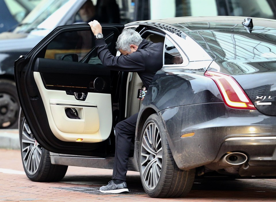  United boss Mourinho climbs into the back of the Jaguar to be driven to training