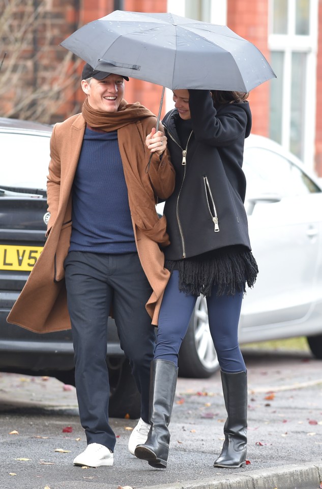  Bastian Schweinsteiger hold the umbrella to protect his wife Ana Ivanovic from the rain