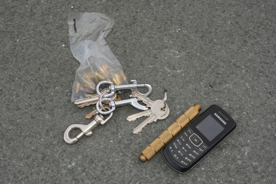  Other object in the holdall include a bag of bullets, keys, a phone and a gold-coloured metal cylinder