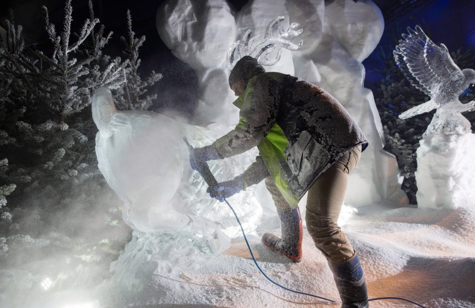  A sculptor puts the finishing touches to one of his creations before the doors to the Winter Wonderland are flung open on Friday