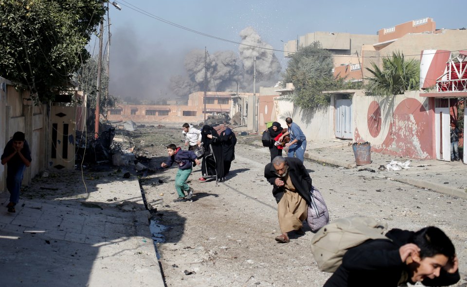 People run in panic after a coalition airstrike hit Islamic State fighters positions in Tahrir neighbourhood of Mosul