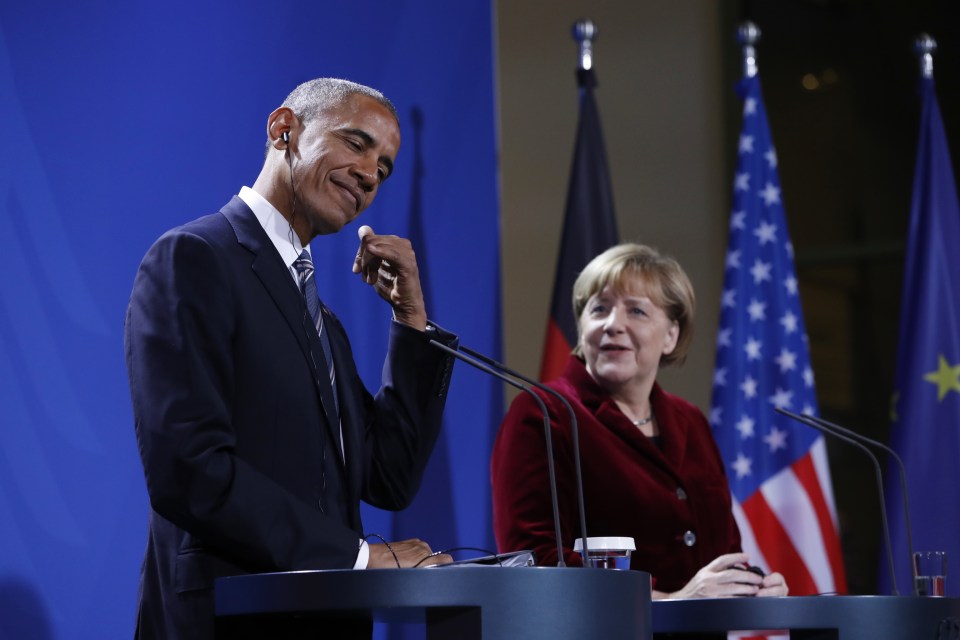  In good spirits ... Obama made a phone gesture and winked at press conference in Berlin as he praised Merkel, calling her an 'outstanding partner'