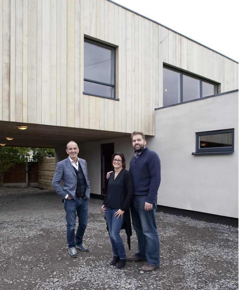 Presenter Kevin McCloud with the couple outside their home