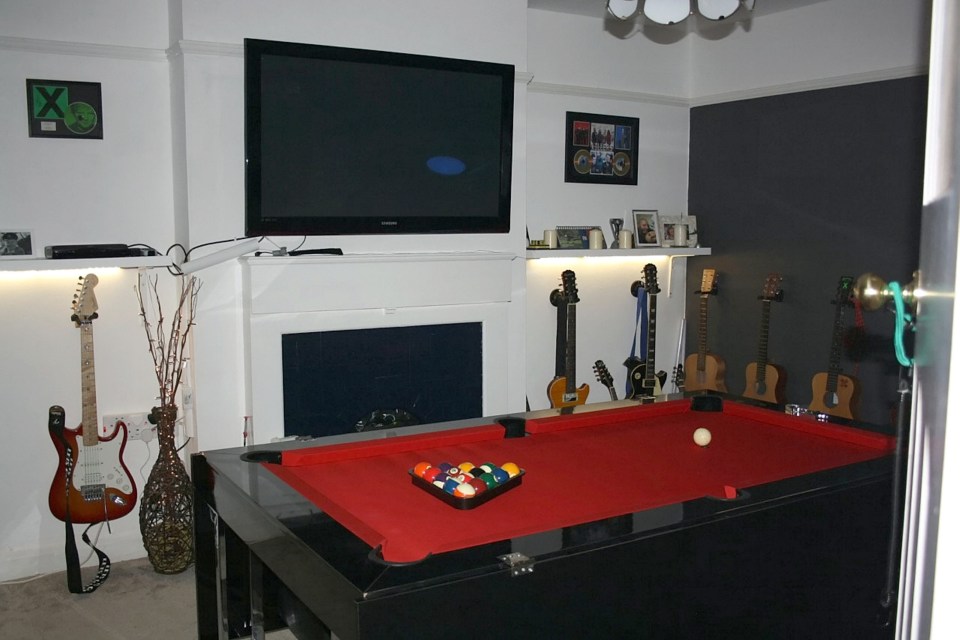 A flatscreen sits above a pool table in one of the ultimate mansaves