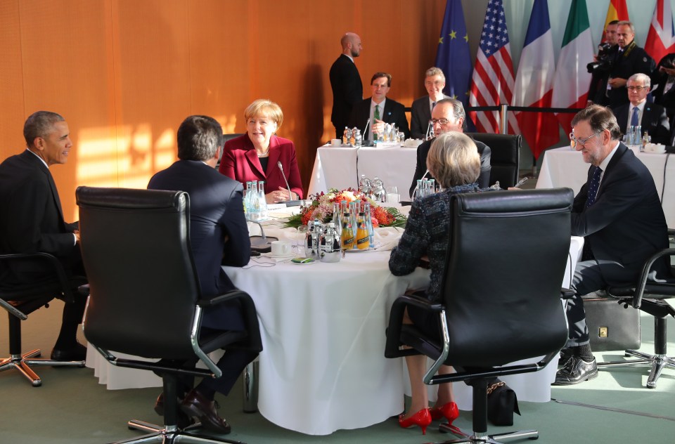 Theresa May sits opposite Angela Merkel and next to Barack Obama in Germany this morning