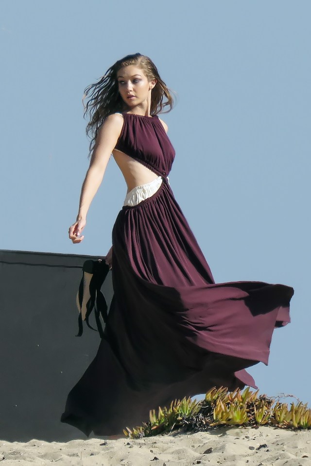 Gigi Hadid looked stunning in a maroon gown as she took part in a photoshoot on Malibu beach