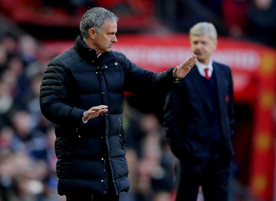 Manchester United's manager Jose Mourinho (L) reacts as Arsenal's manager Arsene Wenger