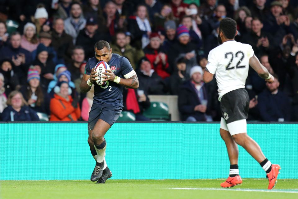  England's Semesa Rokoduguni kisses the ball as he scores his side's eighth