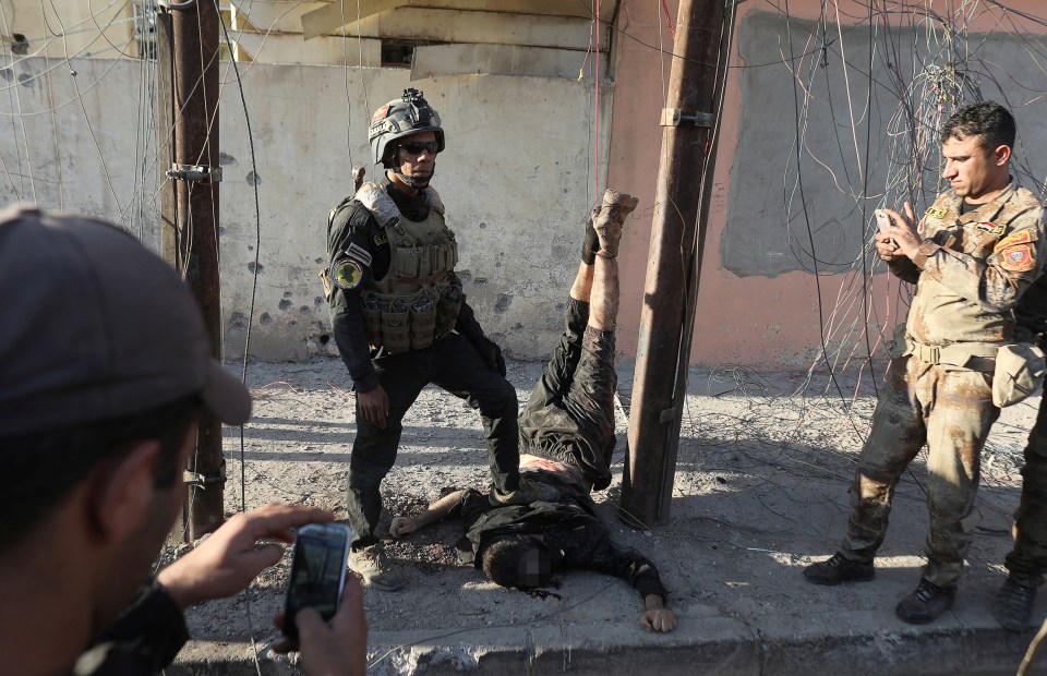  In one picture a soldier rests his foot on the back of the body of the hanging soldier