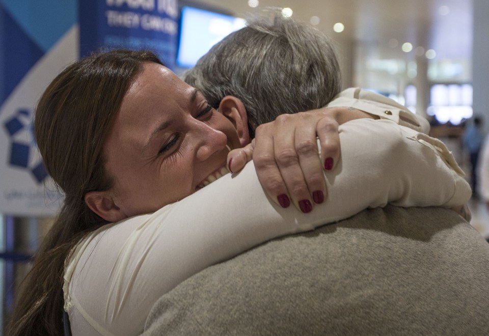  Father and daughter embrace after being reunited during ordeal