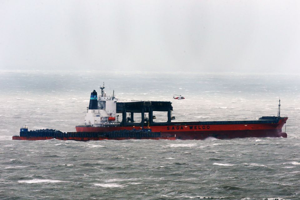  A coast guard helicopter attends the scene where at least eleven crew members have been evacuated from cargo ship Saga Sky