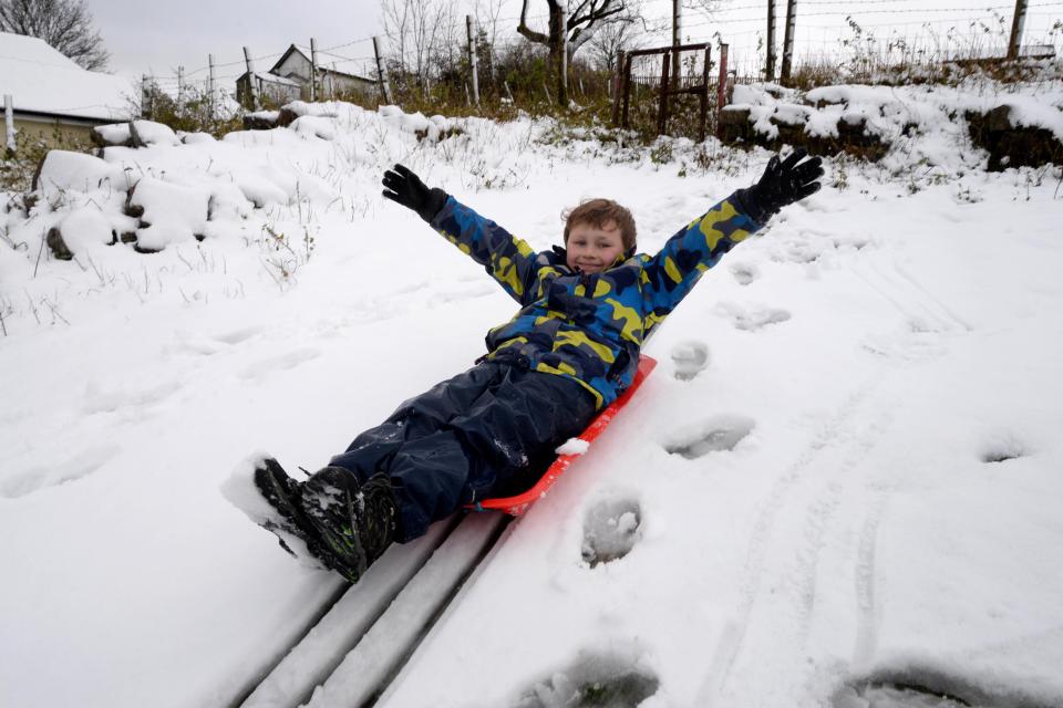  Kid laps up snow on slope in Trefil, South Wales