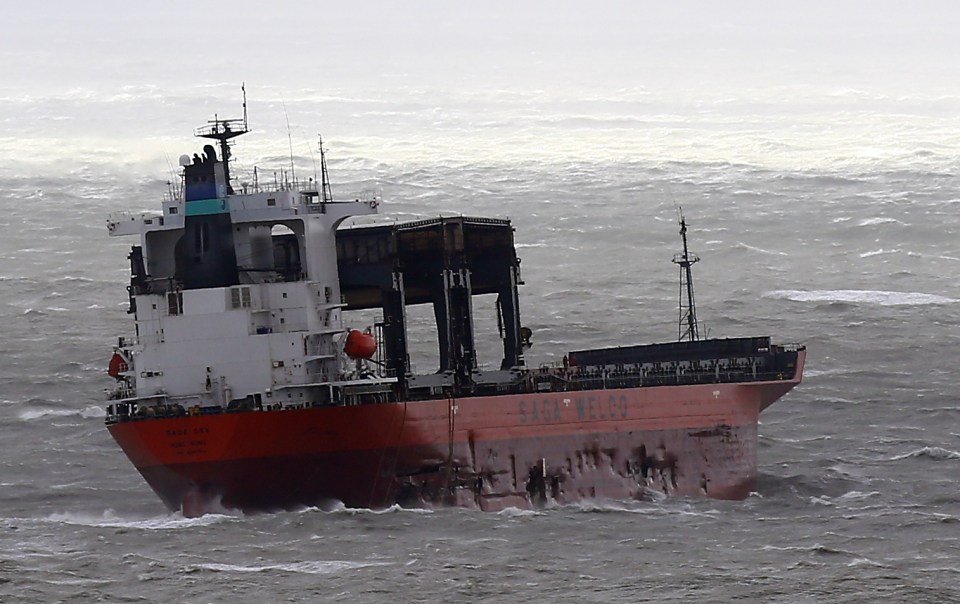  The side of the cargo ship has been severely damaged by the collision with the barge