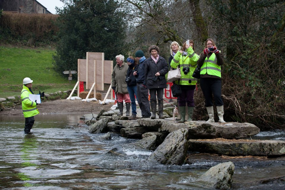  People watch on as work begins to rebuild the Grade 1 listed Tarr Steps after it was destroyed in 2012