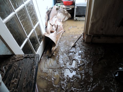  Sludge covered the floor of a Maesteg home, left in ruins after the rain