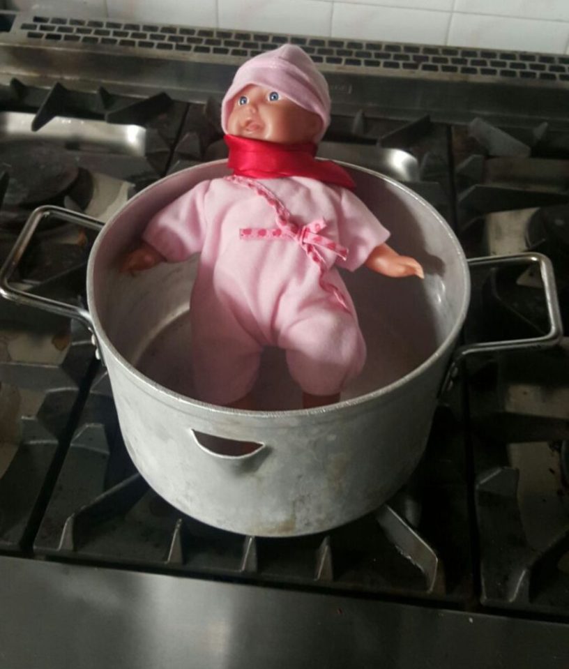  The cruel pair put the doll into a pot to boil it