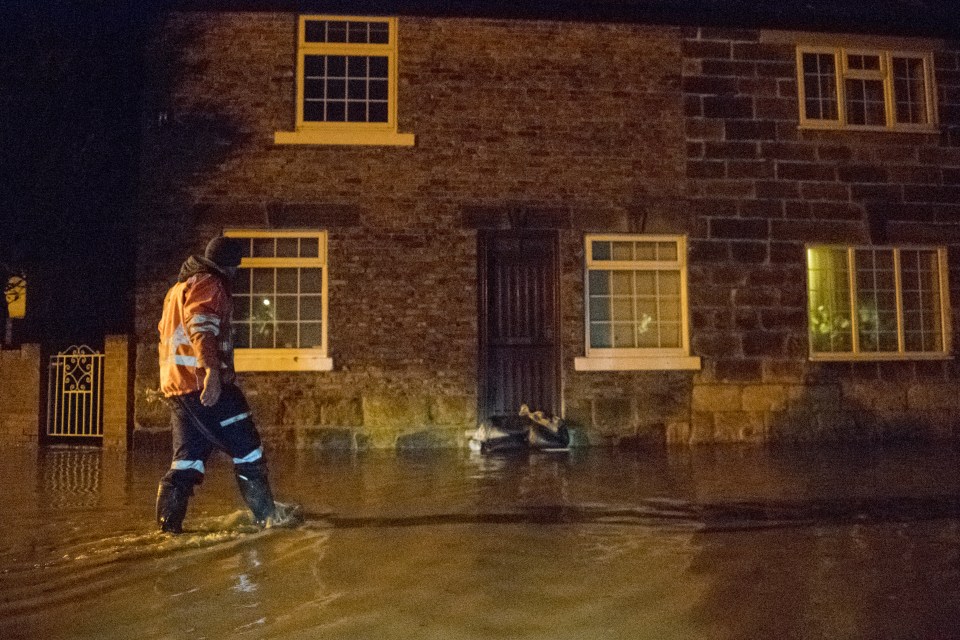  Council workers sandbag doors to protect homes in Great Ayton, North Yorkshire