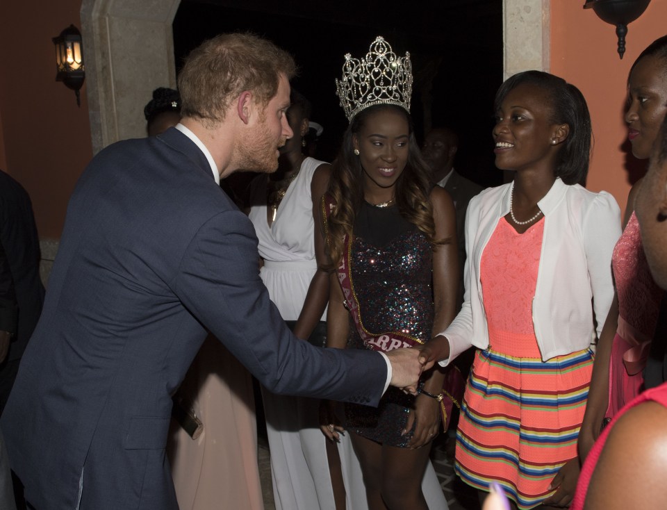 Prince Harry chats to Miss Antigua and a number of young cultural ambassadors from the country 