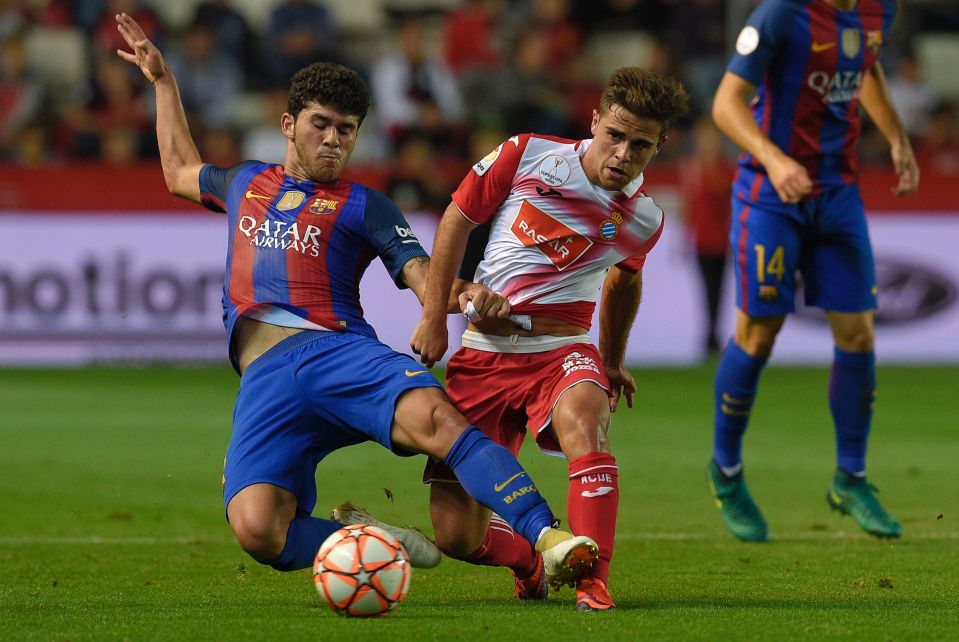 Barcelona's midfielder Carles Alena vies with Espanyol's forward Oscar Melendo