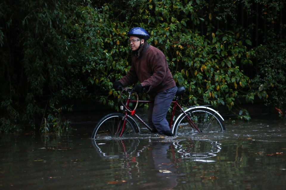  This cyclist was undeterred after the road was swallowed up by a river in Rotherham