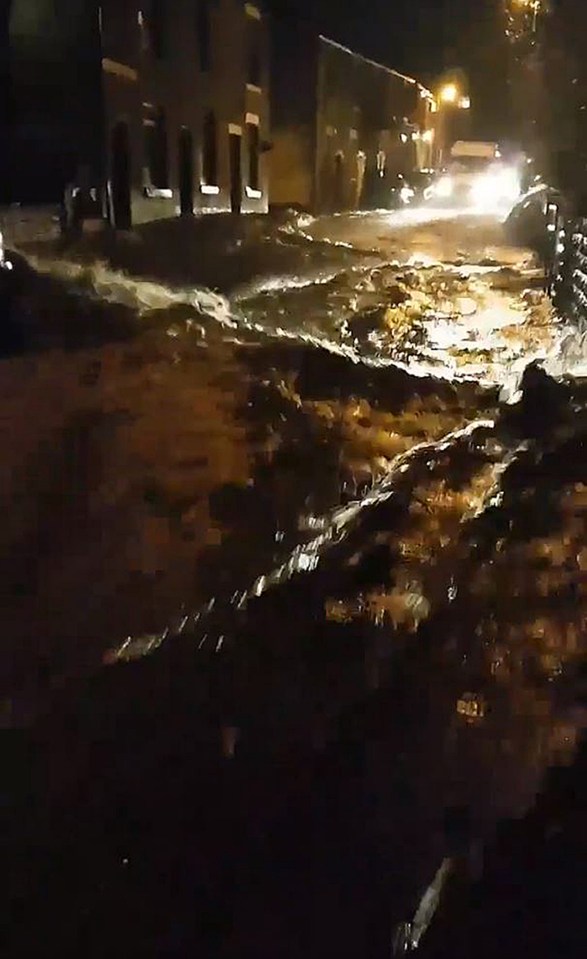  Flood water streams along Micklehurst Road, Mossley