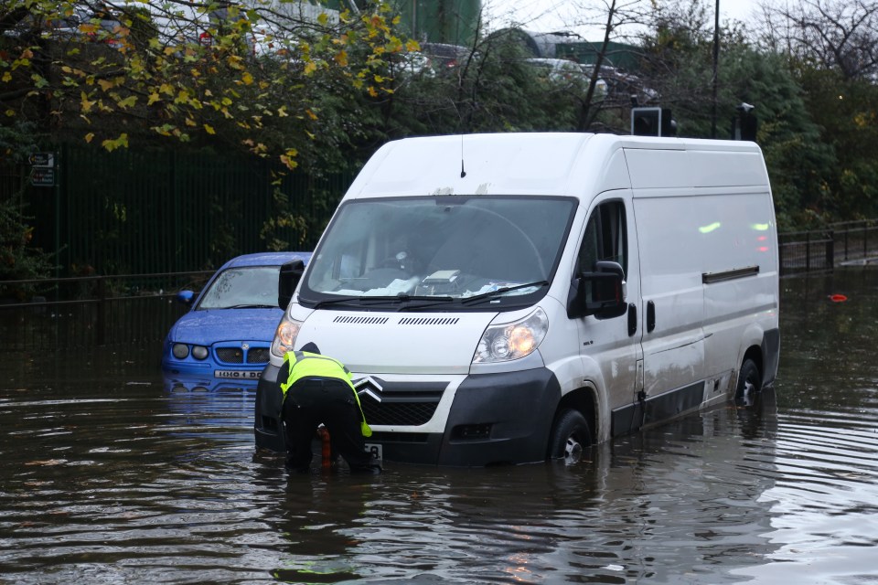  A driver tries to free his van after getting stuck on a flooded road in Rotherham, South Yorkshire