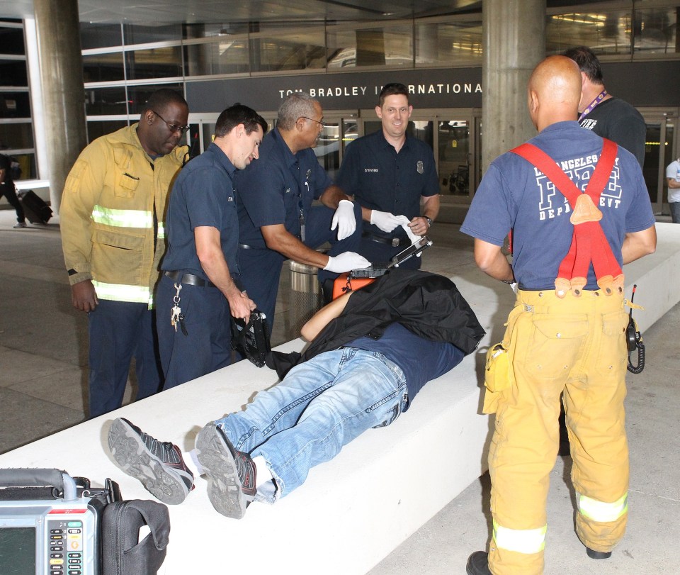  Kanye reportedly beat up a member of the paparazzi, pictured lying down, at LAX airport