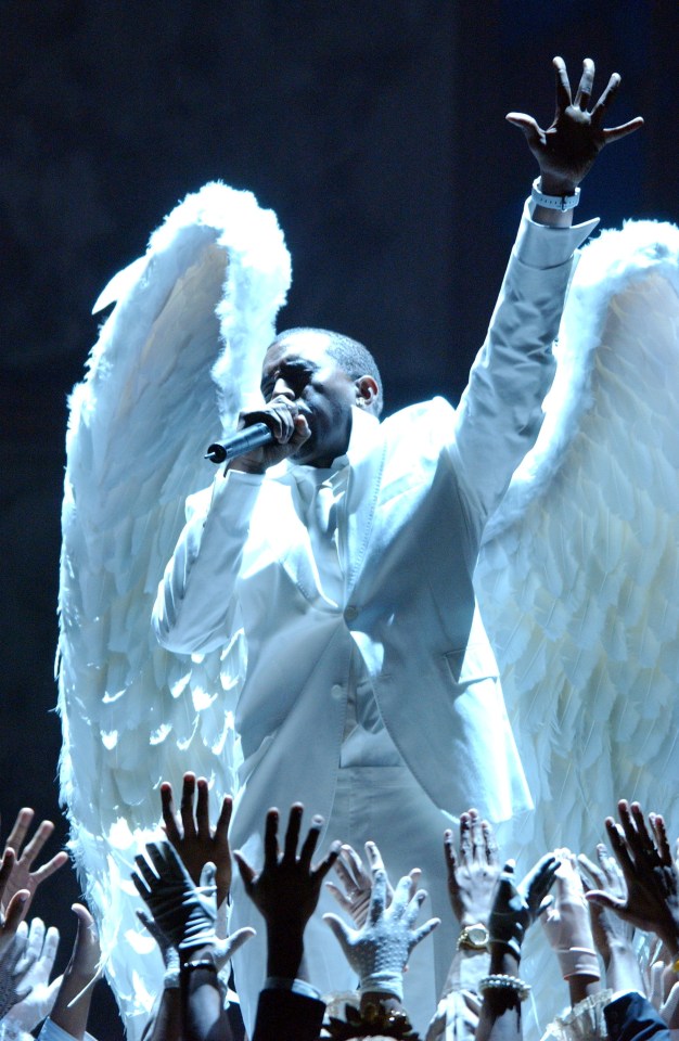  A choir throw their hands towards the sky as a wing-clad Kanye sings at The Grammys