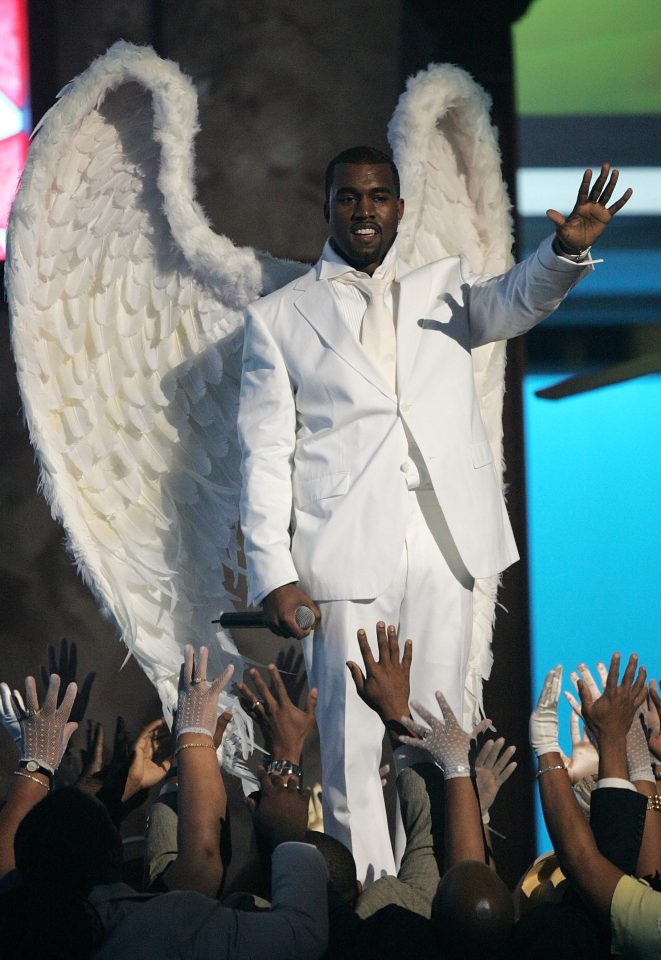  Kanye dons an enormous pair of white angel wings as he 'rises from the dead on stage'