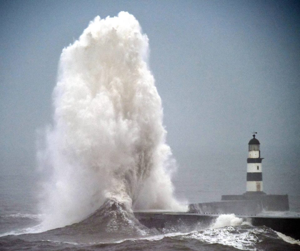  A monster wave crashes on the harbour wall today in Seaham, County Durham, dwarfing the 33ft lighthouse