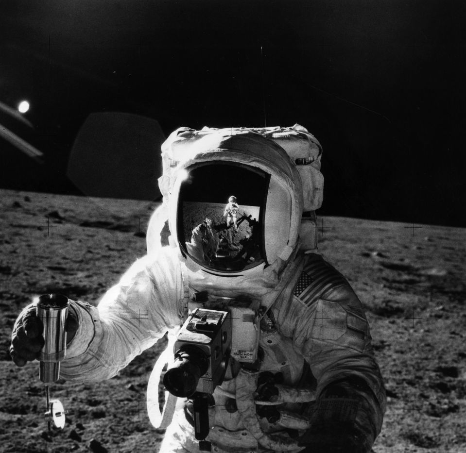  Astronaut Alan Bean with a container of lunar soil collected during Apollo XII mission