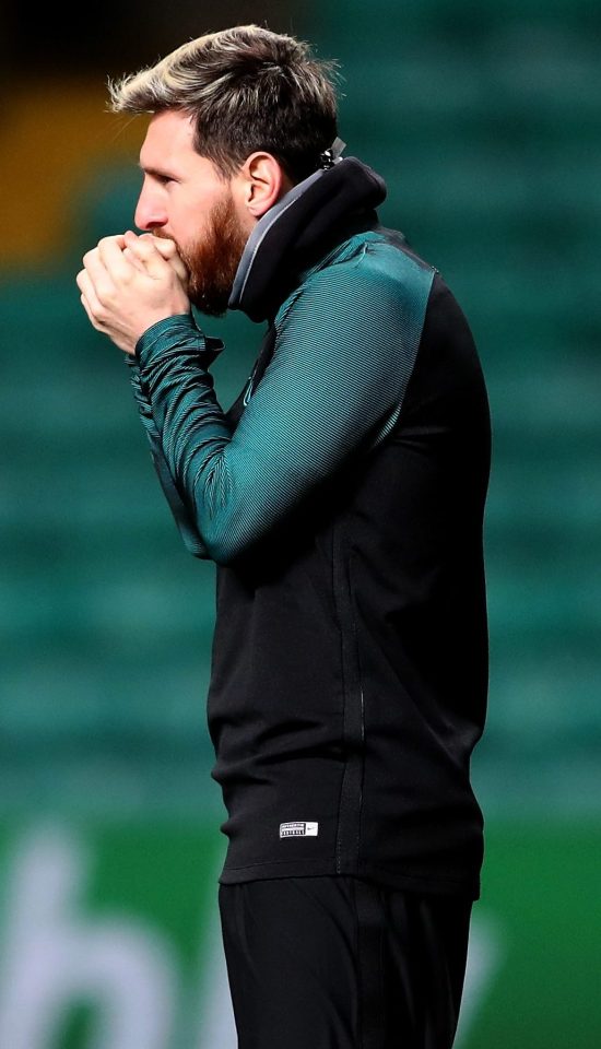  Lionel Messi breaths hot air onto his hands in a desperate attempt to warm up