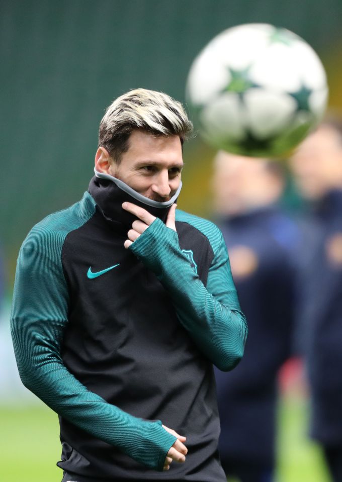  Lionel Messi tries to keep warm as Barcelona train at Celtic Park on Tuesday