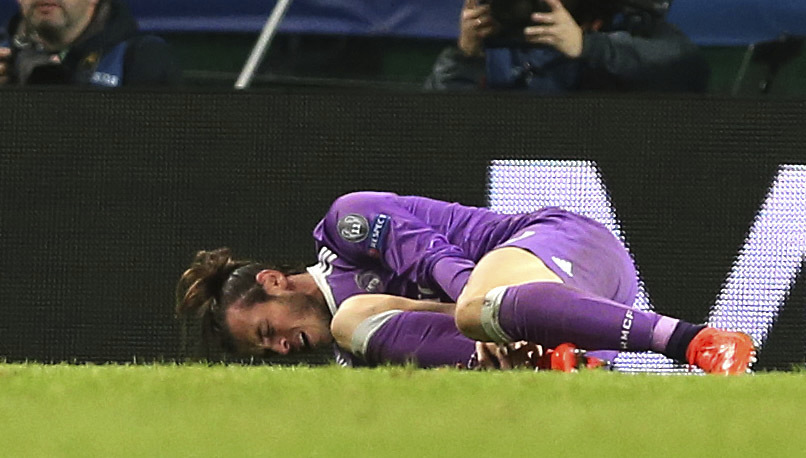  Gareth Bale went down clutching his ankle after a tackle by Sebastian Coates