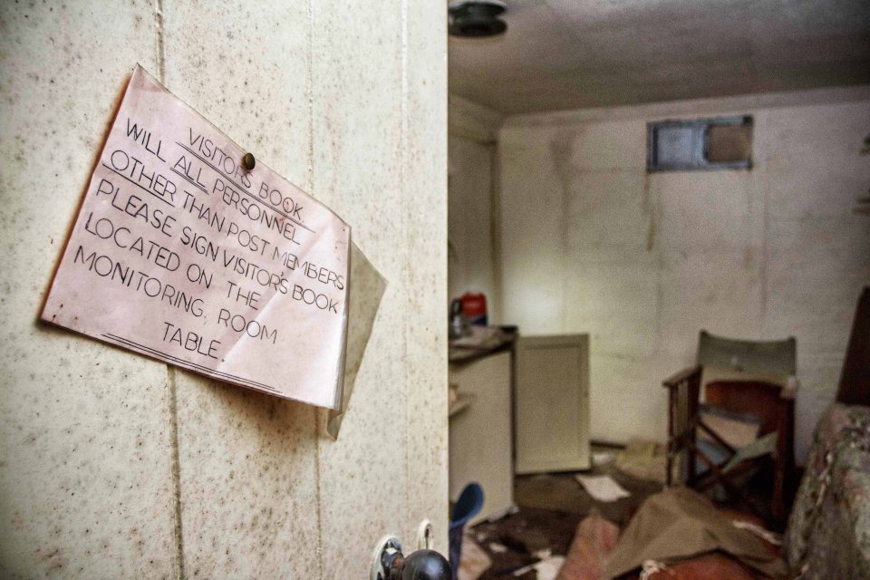 A note on the wall of the bunker asks visitors to sign a special book before leaving