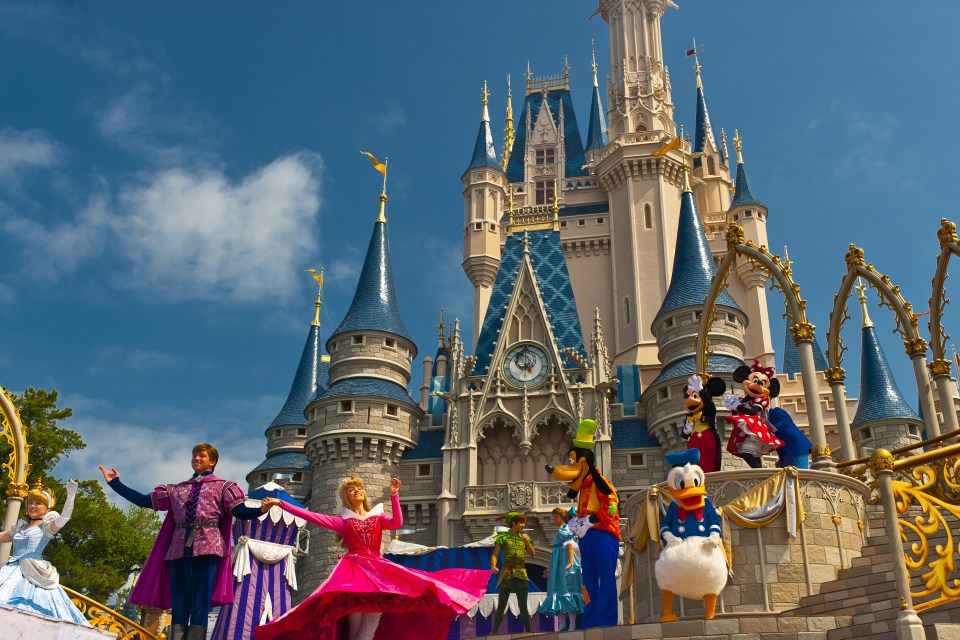 Disney characters perform in front of the Cinderella Castle