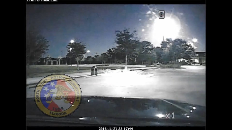  A police squad car films the fireball as it flies overhead