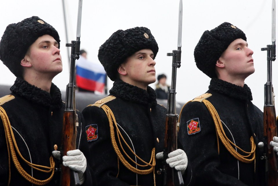  Servicemen at a ceremony to raise Russian Naval ensign aboard the Kolpino sub