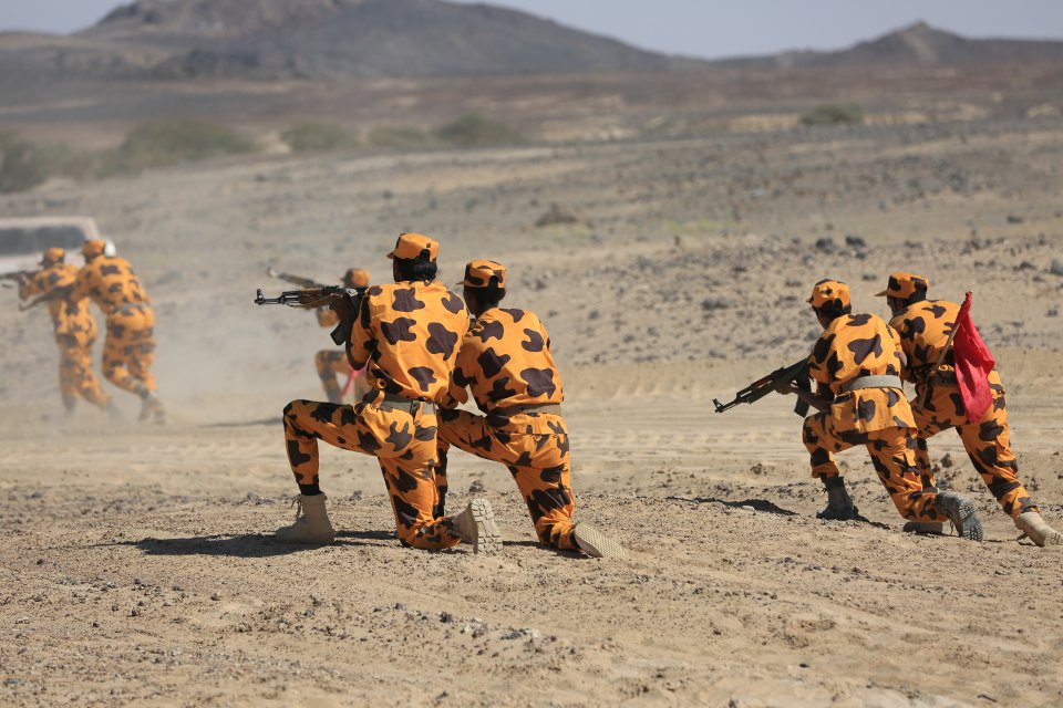  The brightly-clad coppers take part in military drills